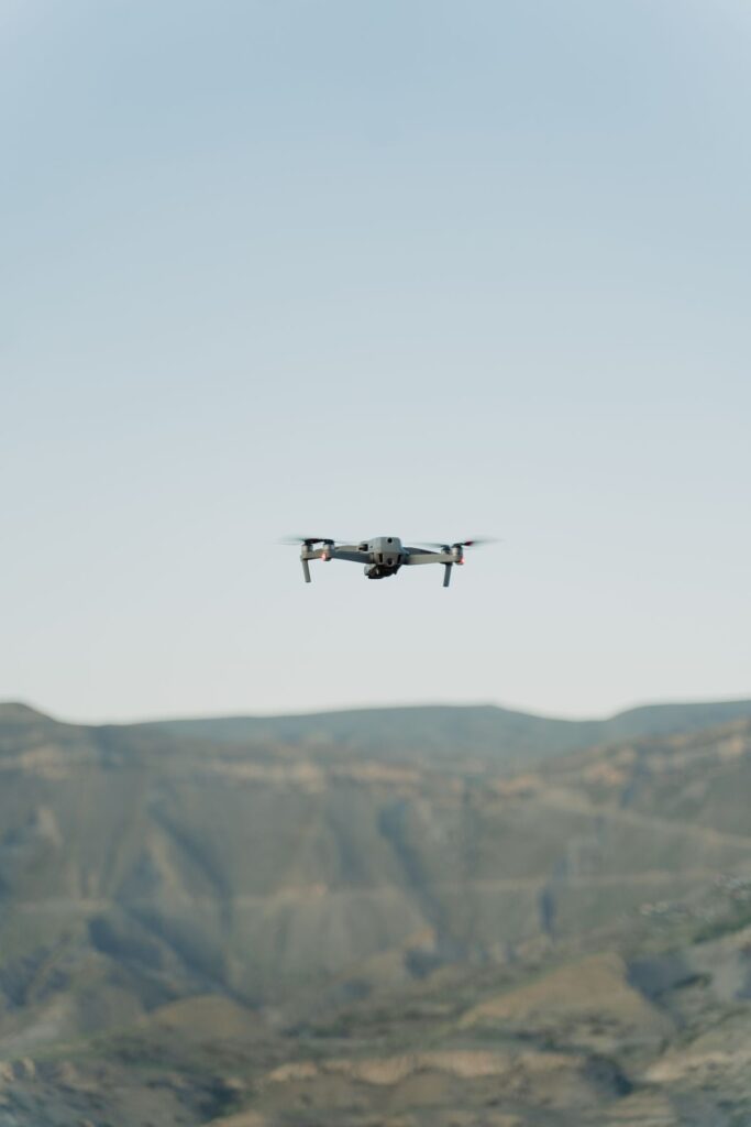 Drone flying over terrain to capture LiDAR survey data